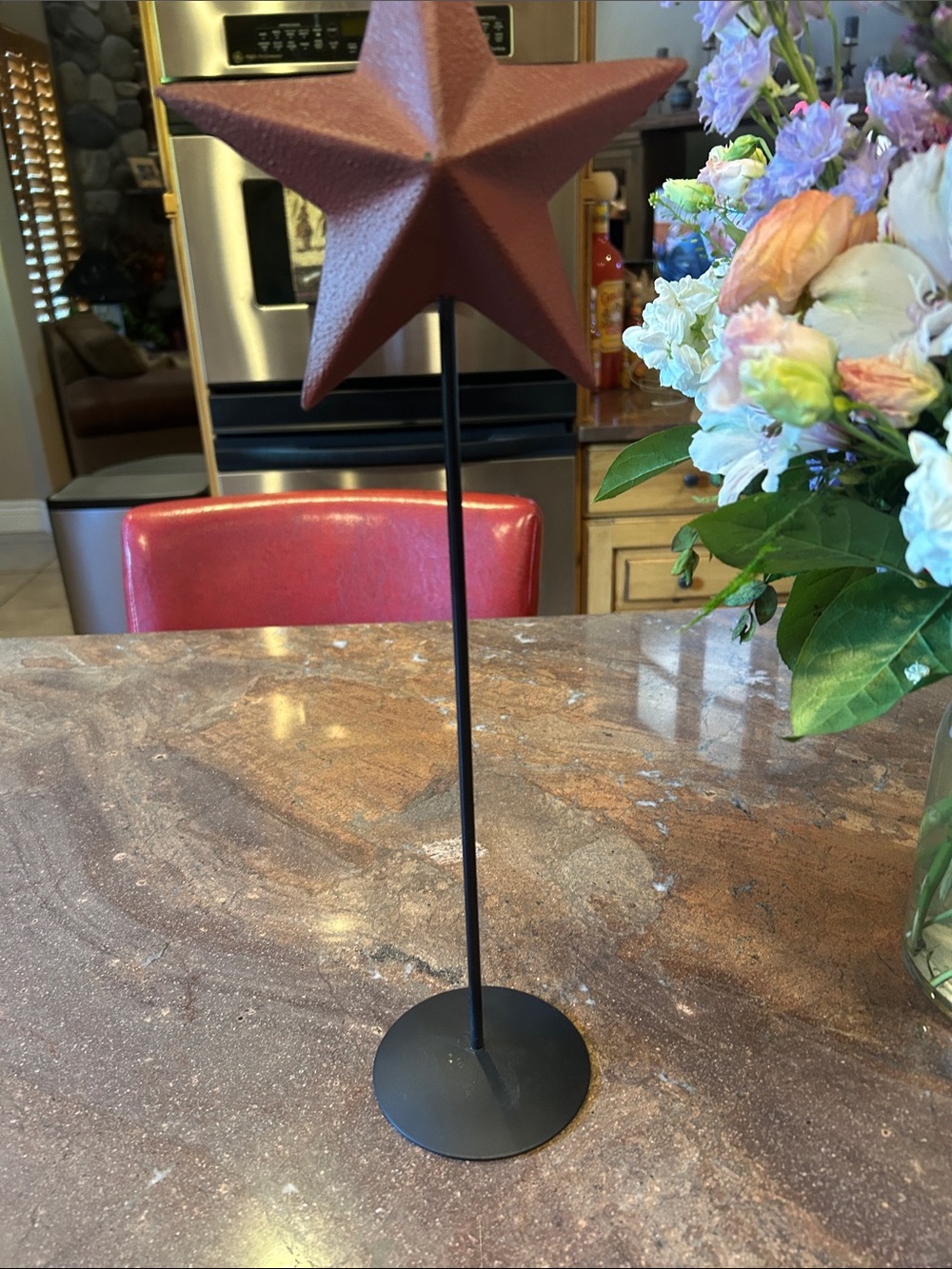Metal Star Table Decor in Rust Red on Black Stand approximately 17 inches tall